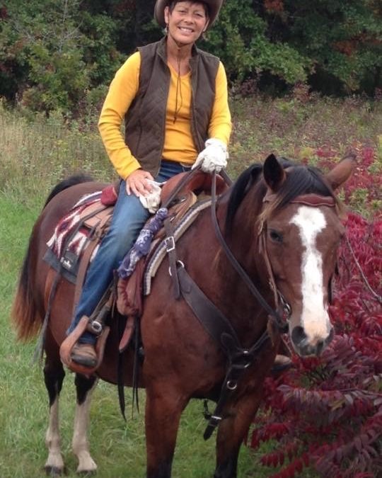 Perri on Horse in Yellow sweater with cowgirl hat