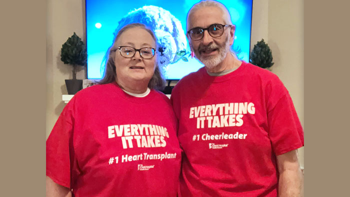 Terri and George Cecere wearing red t-shirts with text, Everything it takes. Terri's says #1 heart transplant. And George's says #1 Cheerleader.