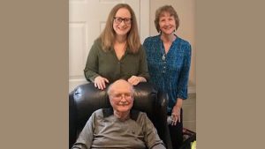 Dr. Stennett seated on chair with Katherine Stennett Rudolph and Stephaie Stennett Ashby