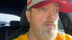 Man in car, tearfully grateful for organ donor